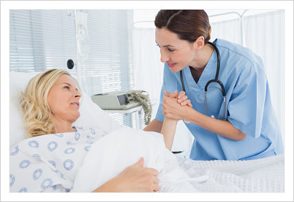 This is a picture of a nurse holding a patient hand while the patient is laying in a hospital.