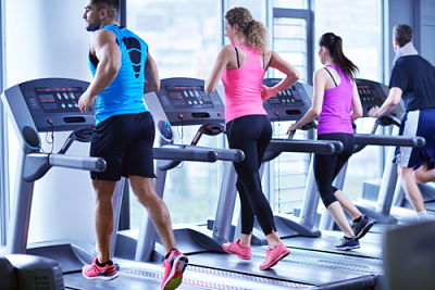 This is a picture of a couple people running on a treadmill
